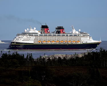 Disney Magic ocean cruise ship underway—Disney Cruise Line family cruises, coastal scenery