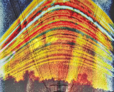 A power line is silhouetted against a vivid sun trails, creating a striking contrast in the landscape