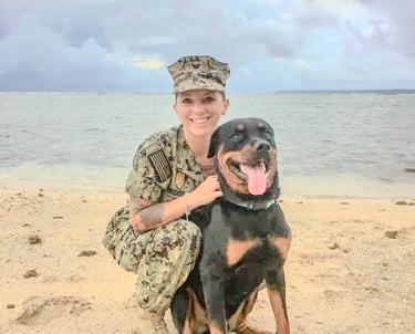 a woman in uniform is holding a dog