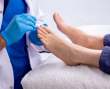 Foot Nurse with a patient's foot in home