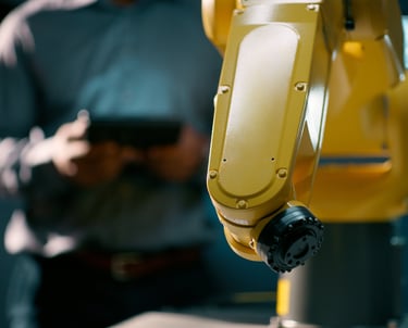 man servicing a fanuc robot