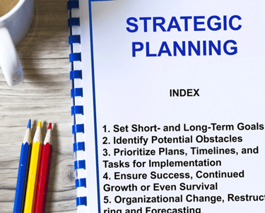 spiral-bound-strategic-plan-showing-table-of-contents-including-goals-potential-obstacles-and-timelilnes