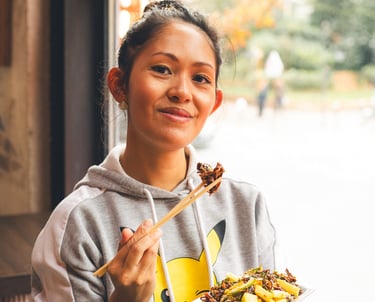a woman holding a plate with a plate of food