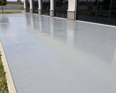 A busy commercial showroom with sleek epoxy flooring reflecting overhead lights.