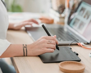 a woman sitting at a desk with a pen and a pen