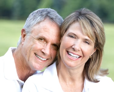 husband and wife smiling
