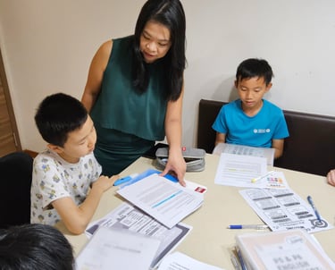 Thriving Kids Club Founder Mrs Serene Wee guiding students during English Tuition class