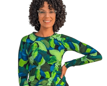 alt="Gina Nusret, infant swim instructor in South Florida smiling in blue and green shirt"