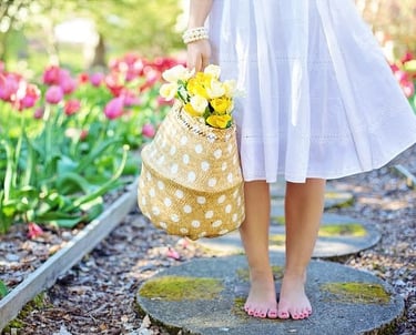 girl holding a basket of flowers