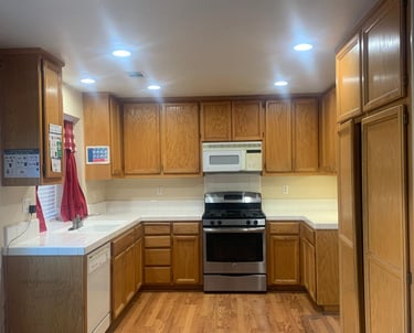 a kitchen with a stove top oven and a microwave