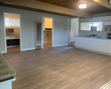 a living room with a couch and a kitchen