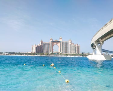 a bridge spanning the water with a bridge in the background in Palm Jumeirah dubai