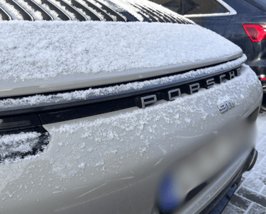 an Enlab Porsche car with a hood on it and a car parked in front of it