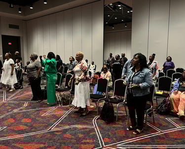 a group of Women leaders gathered in a room with chairs