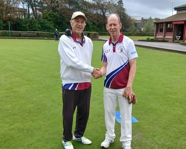 two Porthcawl bowls club players shaking hands before the start of a game