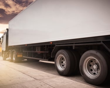 a truck with a trailer parked on the side of the road