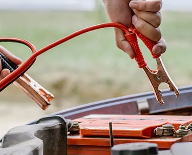 a person holding a jump rope connected to a battery