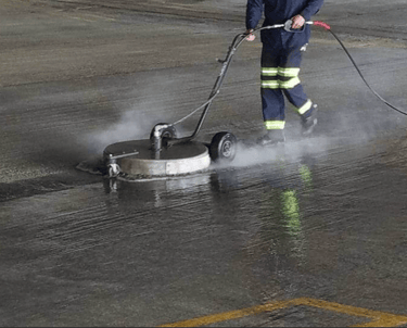 man power washing parking lot