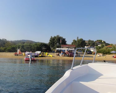 a boat on the water with people on the beach