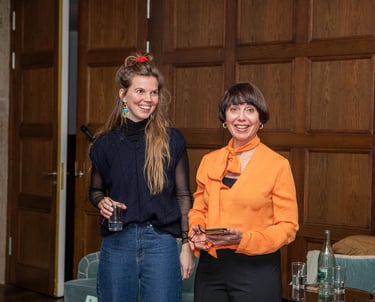 Two confident women, smiling and having fun teaching a seminar for women on public speaking. 