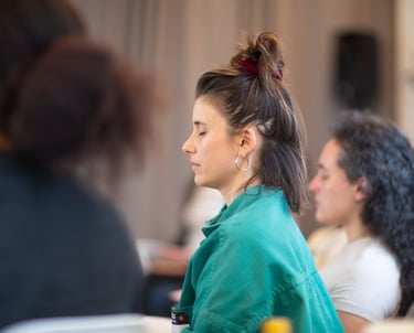 Woman with eyes closed practicing a breathing exercise to prepare for public speaking.
