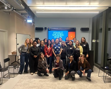 Women standing together after a speaking workshop, smiling proudly at the camera