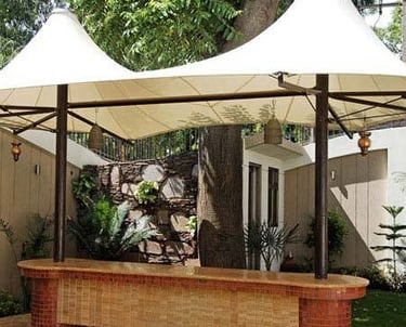 a gazeboar with a white canopy over it