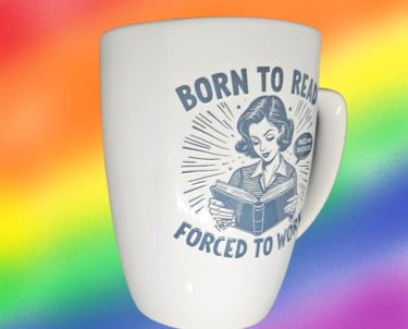 a mug cup of coffee with a woman reading a book