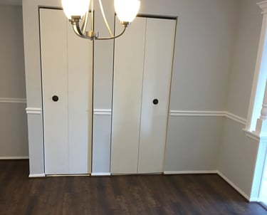 Dark wood-look vinyl plank flooring installed in dining area.