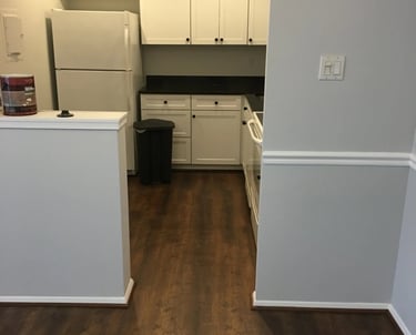 Dark wood-look vinyl plank flooring installed in kitchen.