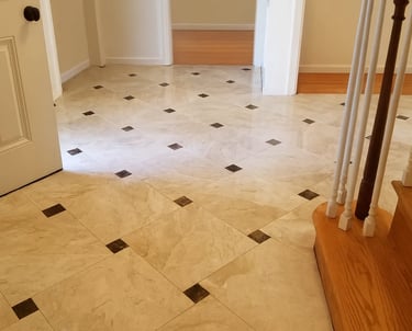 professionally installed polished marble tiles accented with contrasting dark inlays.