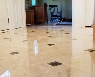 professionally installed polished marble tiles accented with contrasting dark inlays.