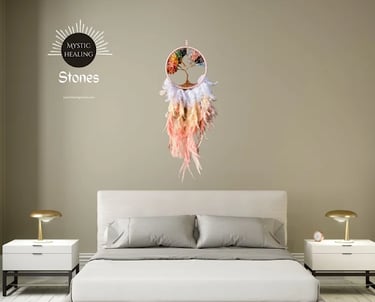 Tree of life dreamcatcher with colorful chakra stones and feathers hanging over a modern bedroom bed