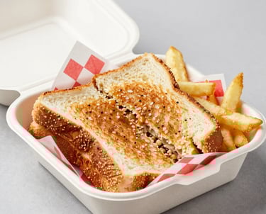 A sophisticated lounge area with black leather chairs and dimmed lighting, inviting guests to relax.
