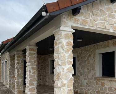 a house with a stone wall and a brick wall