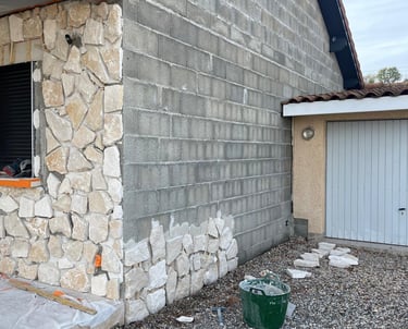 a house with a large window and a green bucket