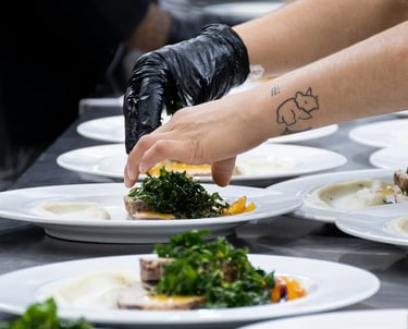 Chef plating dishes for a catering event in Canada