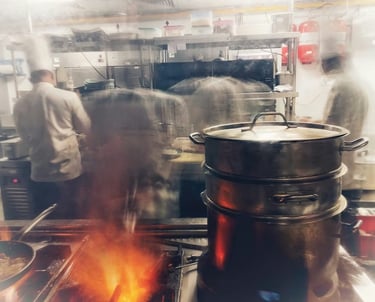 Kitchen staff cooking in a busy commercial kitchen