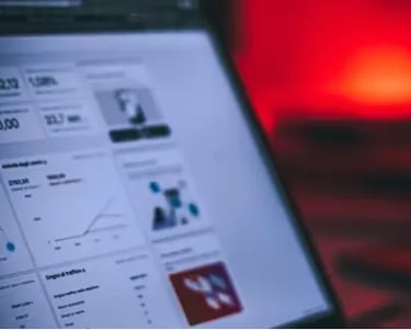 A laptop screen displaying keyword research and SEO analytics charts.