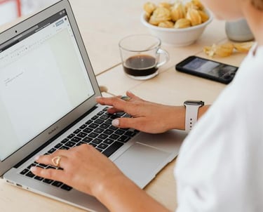 Mujer profesional escribiendo en un portátil en un escritorio