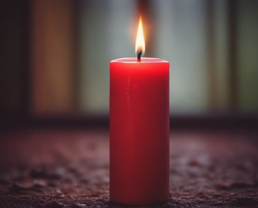 A warm glowing candle in a dark elegant setting with hints of green and gold, symbolizing hope and focus before a football match.