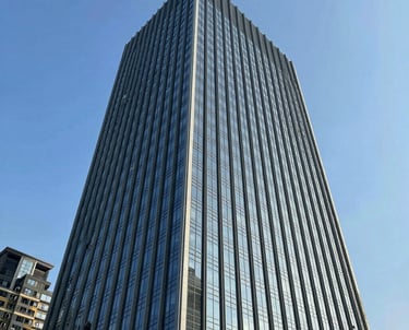 A sleek, modern office space bathed in calming light blue hues, with digital screens displaying futuristic technology concepts.