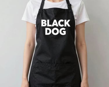 A woman standing in a kitchen wearing an apron