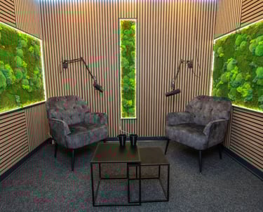 a living room with a mossel plant in the middle of the room