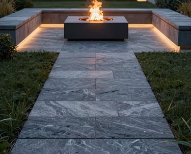 A landscape design visualization showing a modern stone path leading to a minimal outdoor fire pit at night. Elegant lighting.