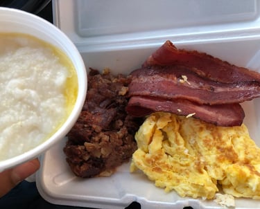 A sizzling breakfast platter with corned beef hash, eggs, and golden homefries at Charlie's Restaura