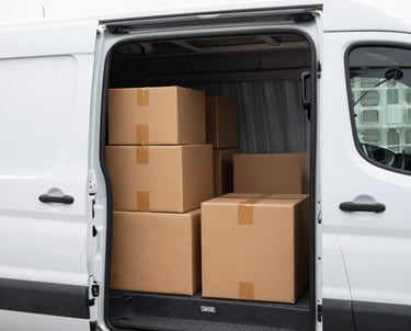 A 2006 Peugeot Partner van loaded with parcels, ready for delivery in an urban neighborhood.