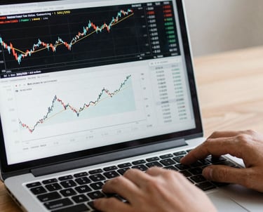 Elegant image of a professional trader analyzing interactive trading charts on a high-tech glass screen.