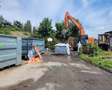Excavator demolition of an asbestos containing structure