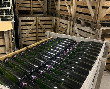 Champagne bottles lying in a wooden crate